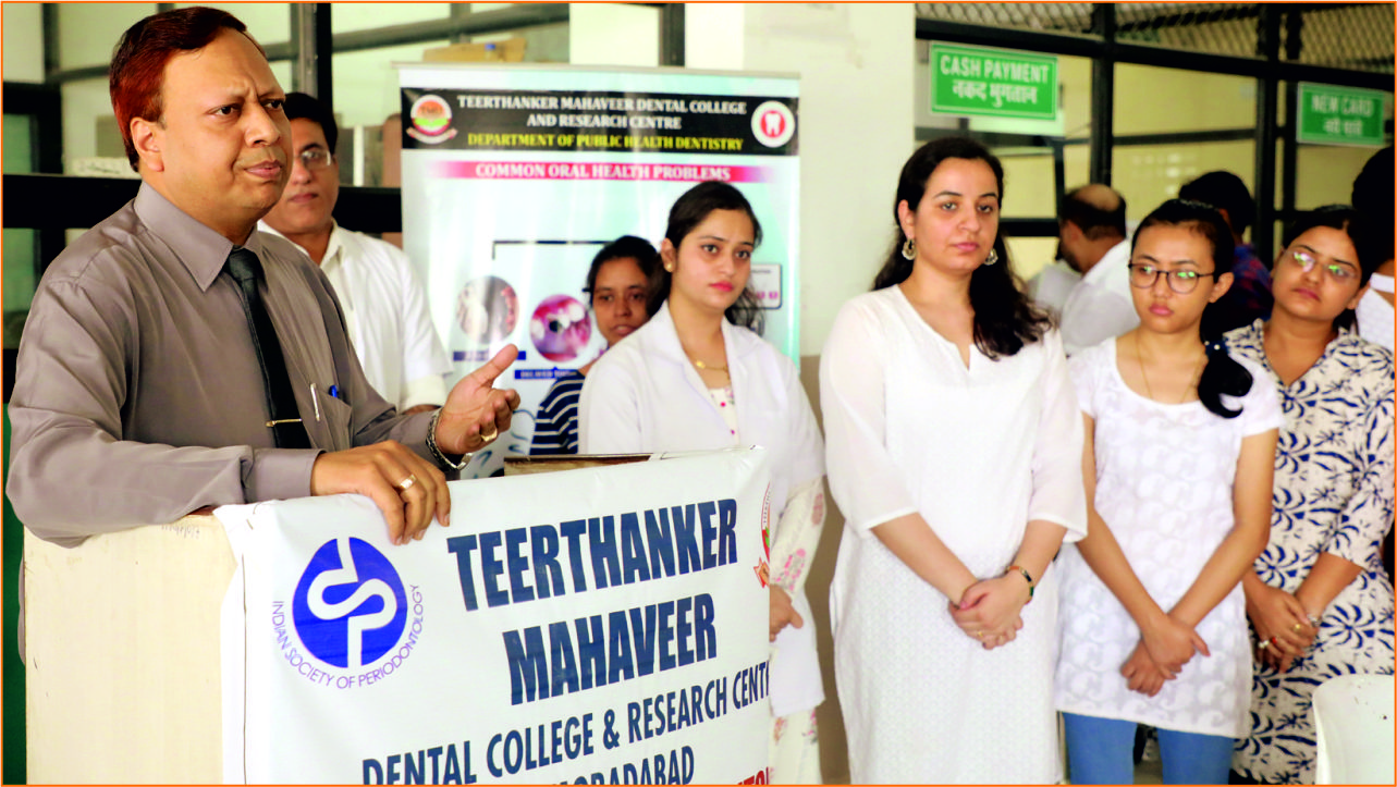 TMU dental college princiapal distributing sanitizer